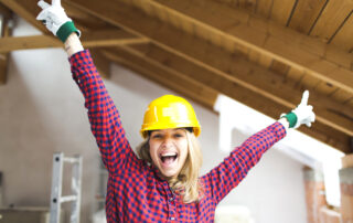 Happy woman with yellow hard hat