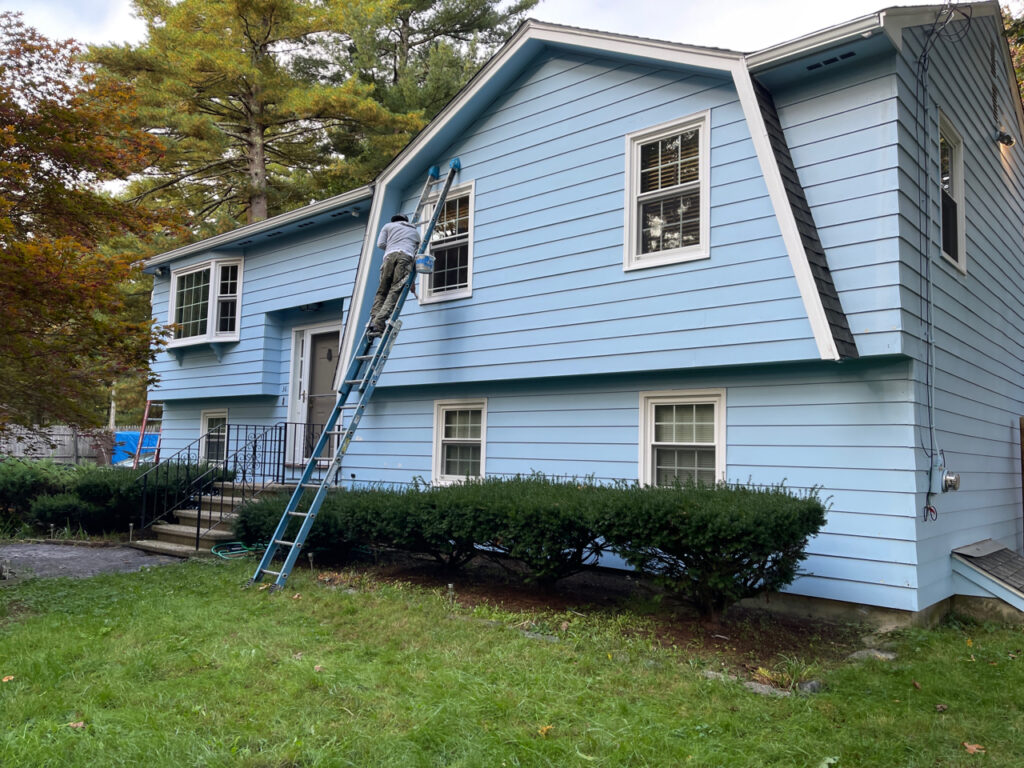 Painter working on home exterior painting