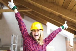 blonde woman overjoyed with construction helmet